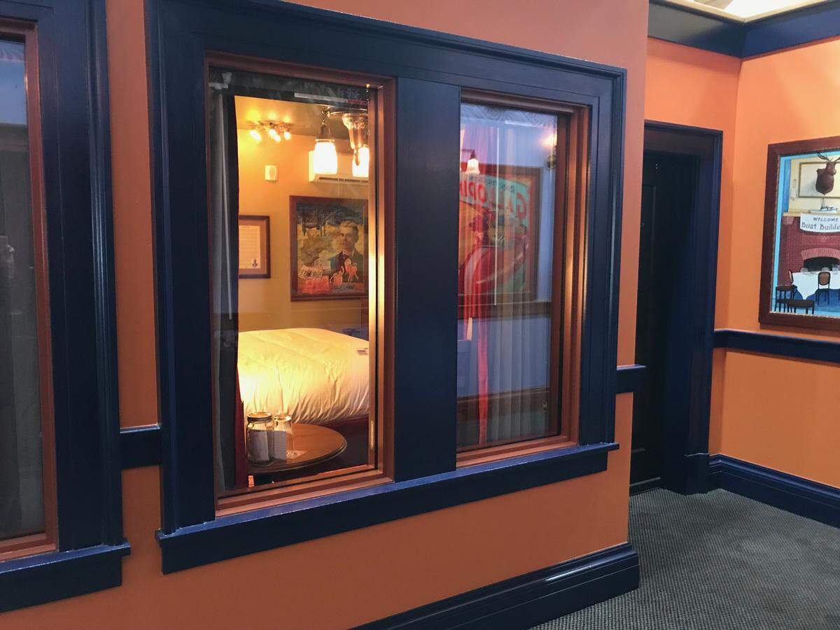 Hotel rooms with interior windows overlooking the hallway were illuminated on opening day for visitors to see inside.