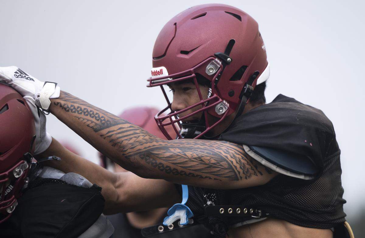 Bethel Linebacker Ramzak Fruean celebrates with teammates during a football practice at Bethel High School on Wednesday, Aug. 27, 2025, in Spanaway, Wash.