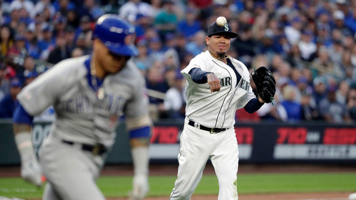 Seattle Mariners starting pitcher Felix Hernandez, right, throws out Chicago Cubs’ Javier Baez on a grounder from Baez during the third inning of a baseball game Tuesday, April 30, 2019, in Seattle. (AP Photo/Elaine Thompson)