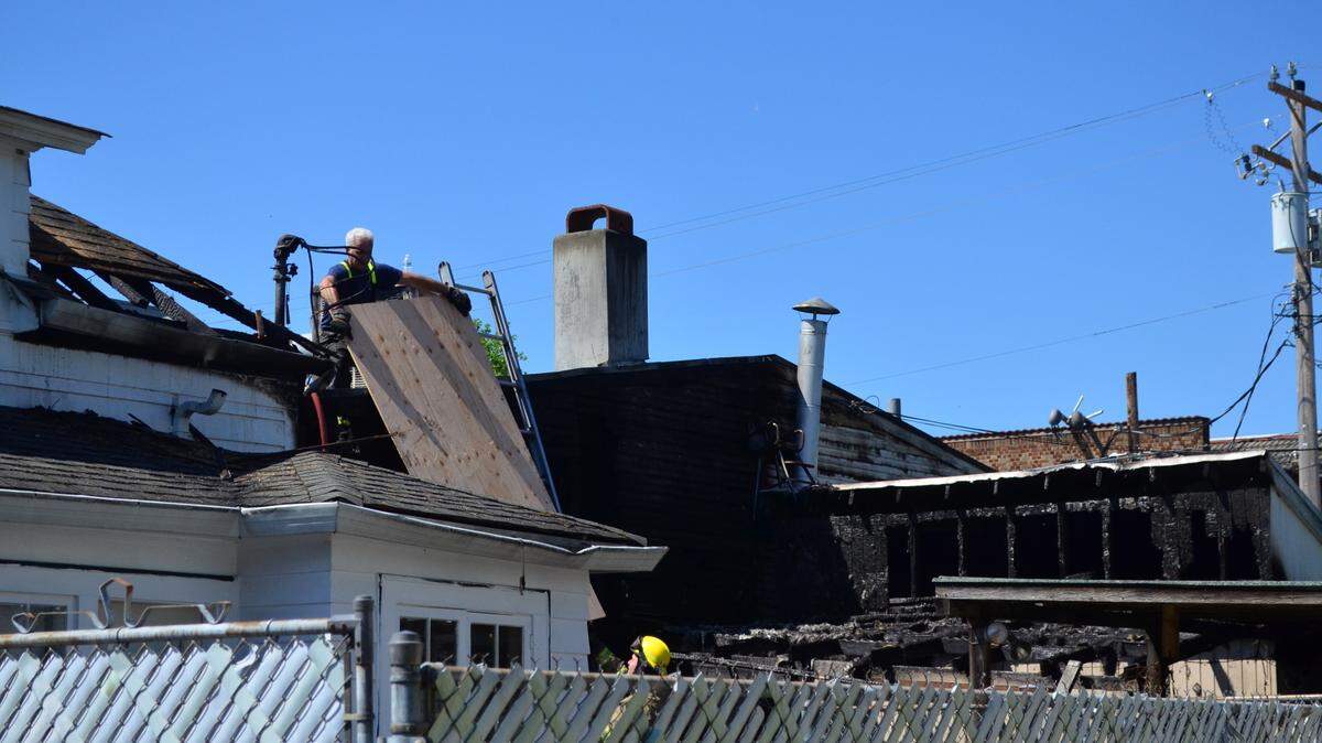 Firefighters from Tacoma Fire Department work the scene of a fire Friday morning on 6th Avenue that damaged two restaurants, one of them a popular brunch spot.