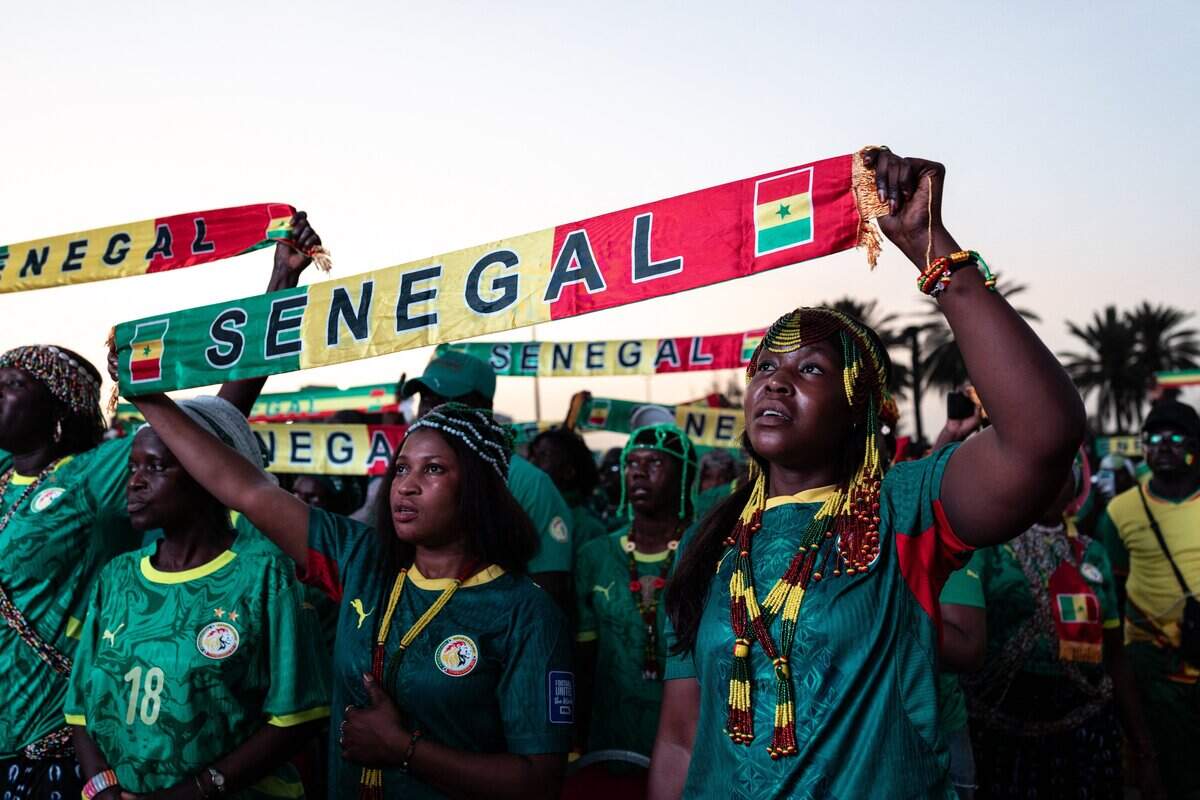 Senegal supporters watch the 2026 World Cup round of 32 football match between Belgium and Senegal at the FIFA Fan Zone at the Place de l'Obelisque in Dakar on July 1, 2026. (Photo by Patrick Meinhardt / AFP via Getty Images)