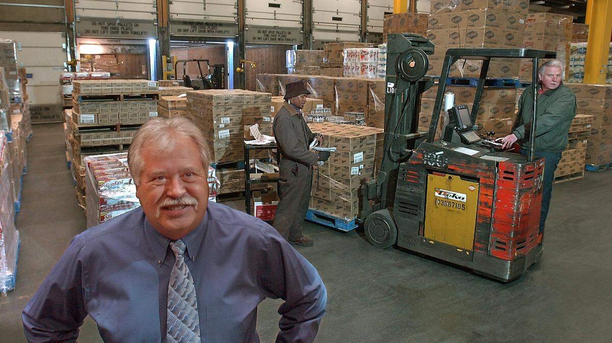 02/17/2005 / BUSINESS SLUG: SUPERVALU Larry Langsweirdt, Northwest Region President of Supervalu (left) standing on the 600,000 square foot warehouse floor which holds 8000 different products. In the background (Photo I.D. left to right) Joe Anthony uses the scanner as Ralph Gasser rides the forklift to move Zip Lock bag products and others being off loaded from trailers in doors 7 through 9 pictured in the background. The Tacoma warehouse serves retailers in Idaho, Montana, Oregon and Washington, as well as Alaska and the Pacific Rim through the Port of Tacoma. (Russ Carmack/The News Tribune) 02/17/2005