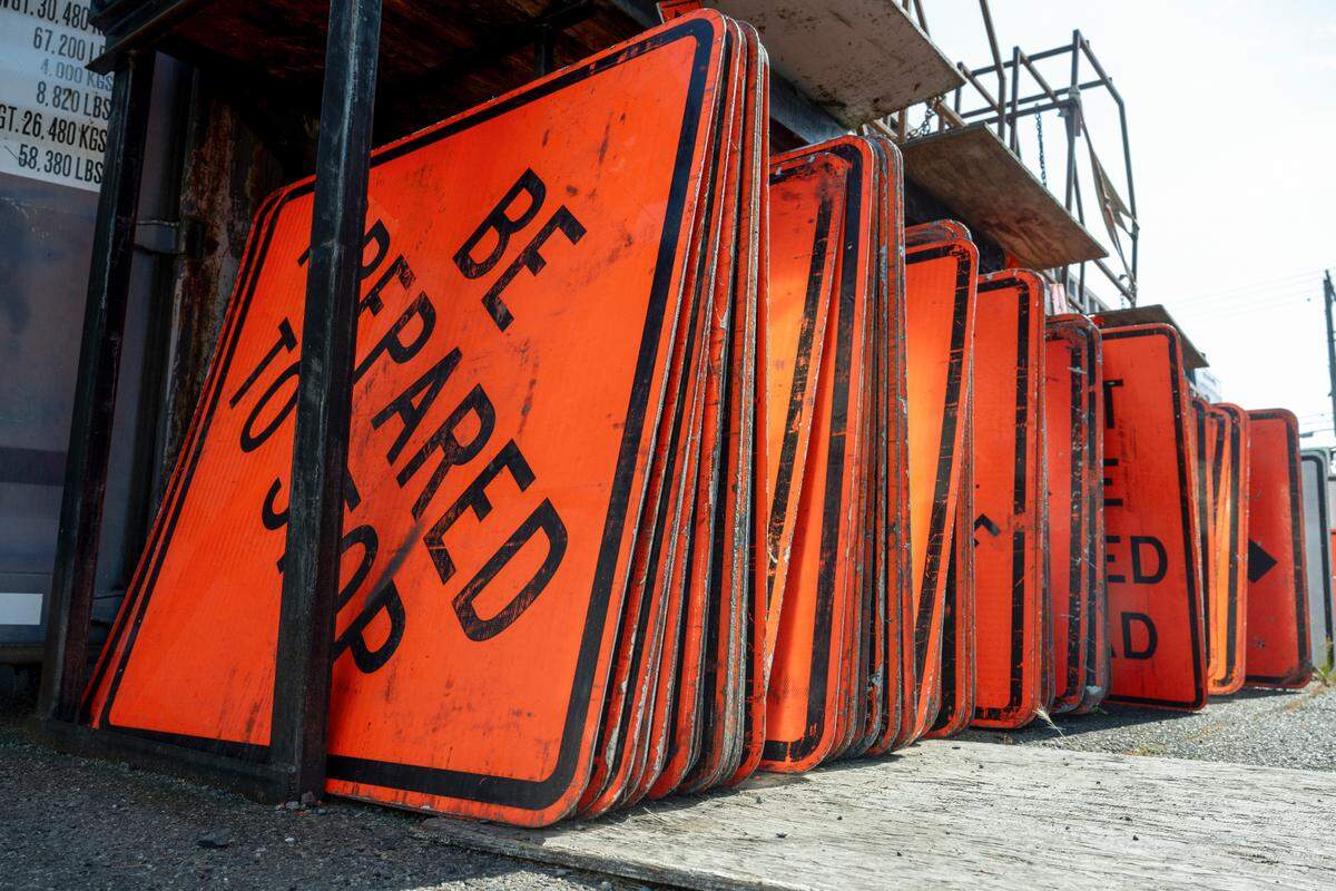 Safety equipment supplies, including traffic signs, are stored behind the office for Advanced Government Services on Tuesday, June 24, 2025, in Tacoma, Wash. When president Arti O’Brien gained ownership of AGS in 2016, the company was still considered a small business and was helped by the Minority Business Development Agency to develop into the business it is today.