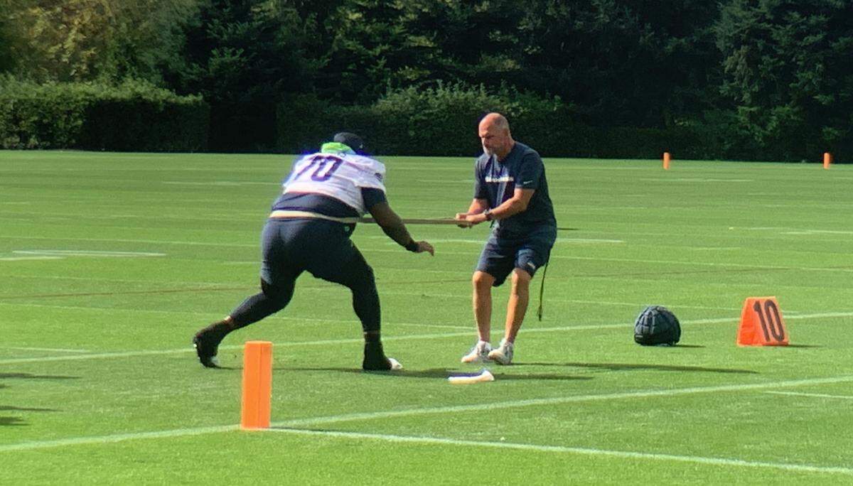 Jason Peters, 41, works on his leg strength with a trainer and a band at the start of Seahawks practice in Renton, Sept. 20, 2023. Seattle signed the former Philadelphia Eagles All-Pro and Super Bowl-champion offensive tackle Sept. 13.
