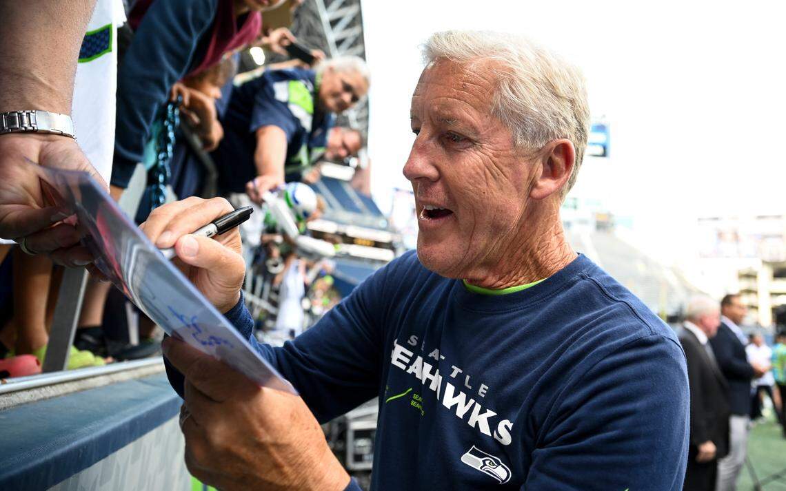 Seattle Seahawks head coach Pete Carroll signs autographs before of the preseason game against the Minnesota Vikings at Lumen Field, Thursday, Aug. 10, 2023, in Seattle, Wash.