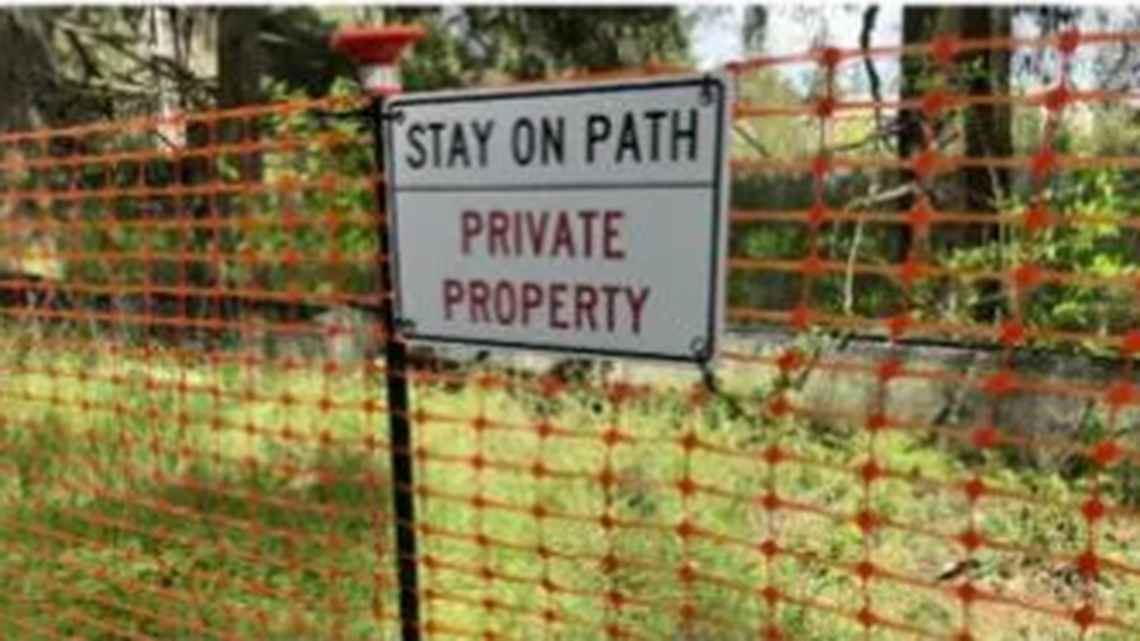 Orange plastic fencing was put up along the Sequalitchew Creek Trail in DuPont in April 2026, as development of a new warehouse facility nearby continues.