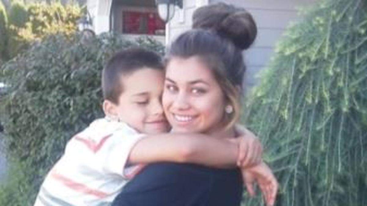 Skylar Seward, right, holding her younger brother.