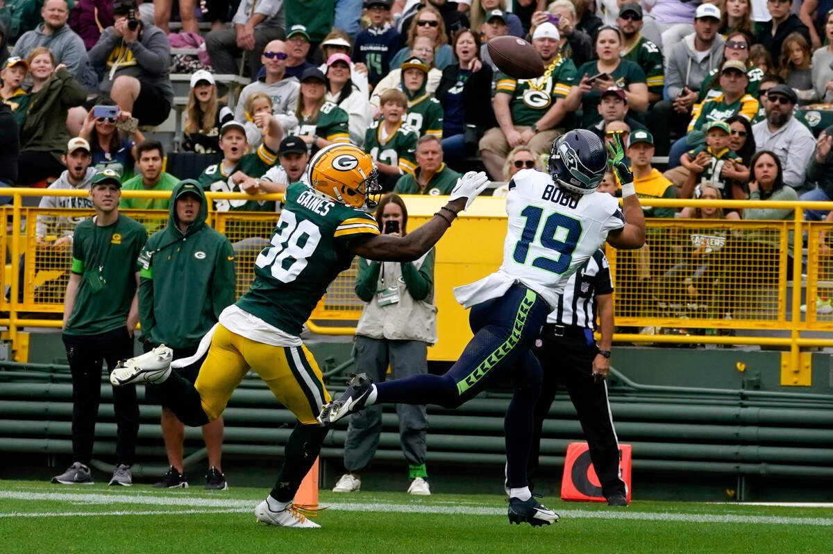 Seattle Seahawks wide receiver Jake Bobo (19) catches an 18-yard touchdown pass in front of Green Bay Packers safety Innis Gaines (38) in the first half of a preseason NFL football game, Saturday, Aug. 26, 2023, in Green Bay, Wis. (AP Photo/Kiichiro Sato)