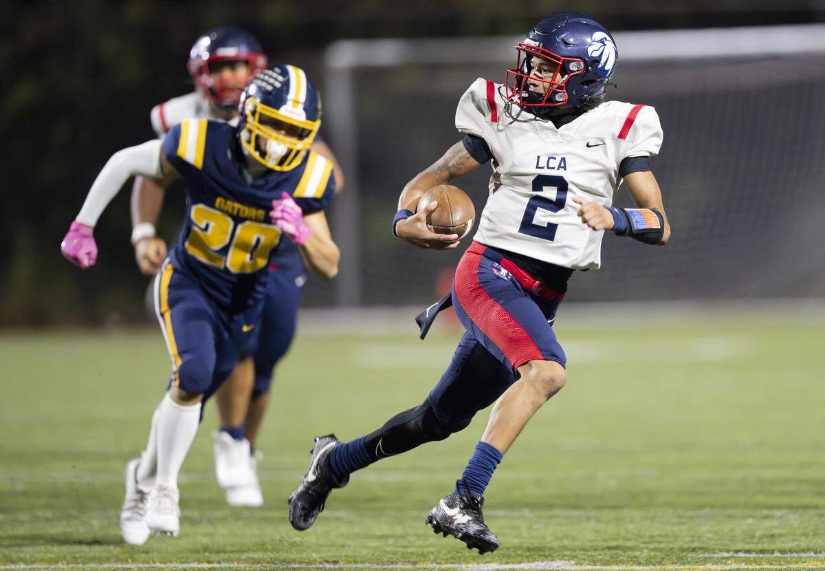 Life Christian quarterback Jabez Boyd (2) keeps the ball against the Annie Wright Gators during the first half of the game at Stadium High School, on Thursday, Oct. 2, 2025, in Tacoma, Wash.