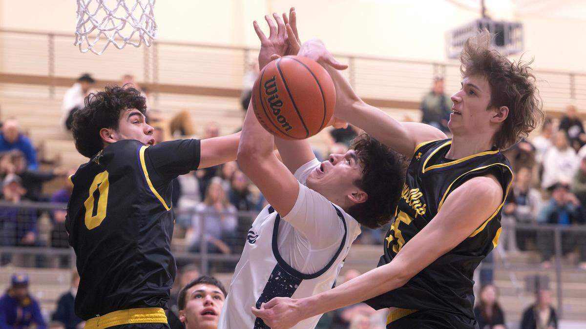 Olympia’s Brian Stevenson gets shut down by Puyallup defenders Mason Sonntag (left) and Will Nasinec during Tuesday night’s 4A SPSL boys basketball game at Olympia High School in Olympia, Washington, on Jan. 14, 2025. Olympia won the game, 62-53.