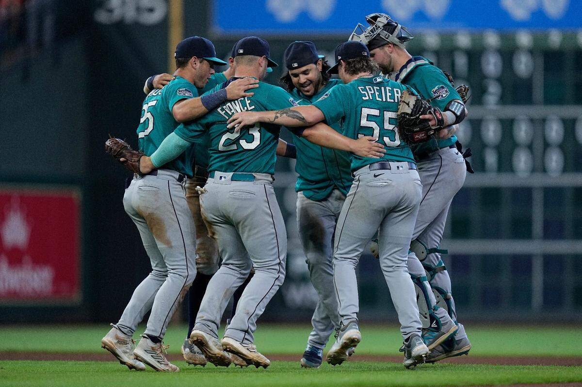 The Seattle Mariners infielders dance after a baseball game against the Houston Astros, Sunday, Aug. 20, 2023, in Houston. (AP Photo/Kevin M. Cox)