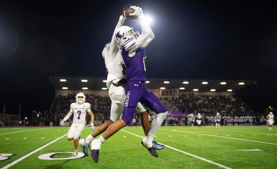Sumner wide receiver Braylon Pope skies to pull in a pass in front of Graham Kapowsin defensive back Jayce Halasz during Friday night’s football game at Sunset Chev Stadium in Sumner, Washington, on Nov. 1, 2024. Sumner won the game, 23-11.