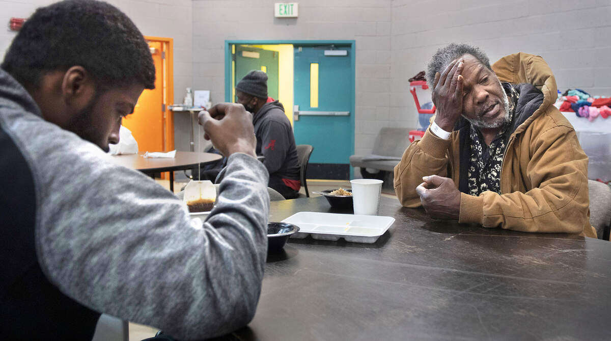 DeJahwan Gwynn (left) and Tony McCreary chat as they get a hot breakfast at the RISE warming center in Tacoma, Washington, on Tuesday, Dec. 28, 2021.
