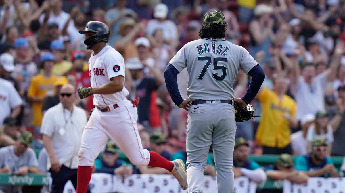 Seattle Mariners’ Andres Munoz (75) watches as Boston Red Sox’s Franchy Cordero, left, runs the bases toward home after hitting a grand slam in the tenth inning of a baseball game Sunday, May 22, 2022, in Boston. (AP Photo/Steven Senne)
