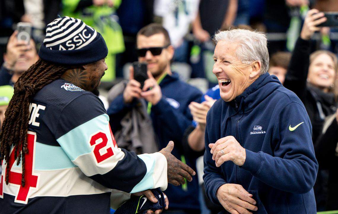Former Seahawk running back Marshawn Lynch and head coach Pete Carroll share a laugh before the game against the Pittsburgh Steelers at Lumen Field, on Sunday, Dec. 31, 2023, in Seattle, Wash.