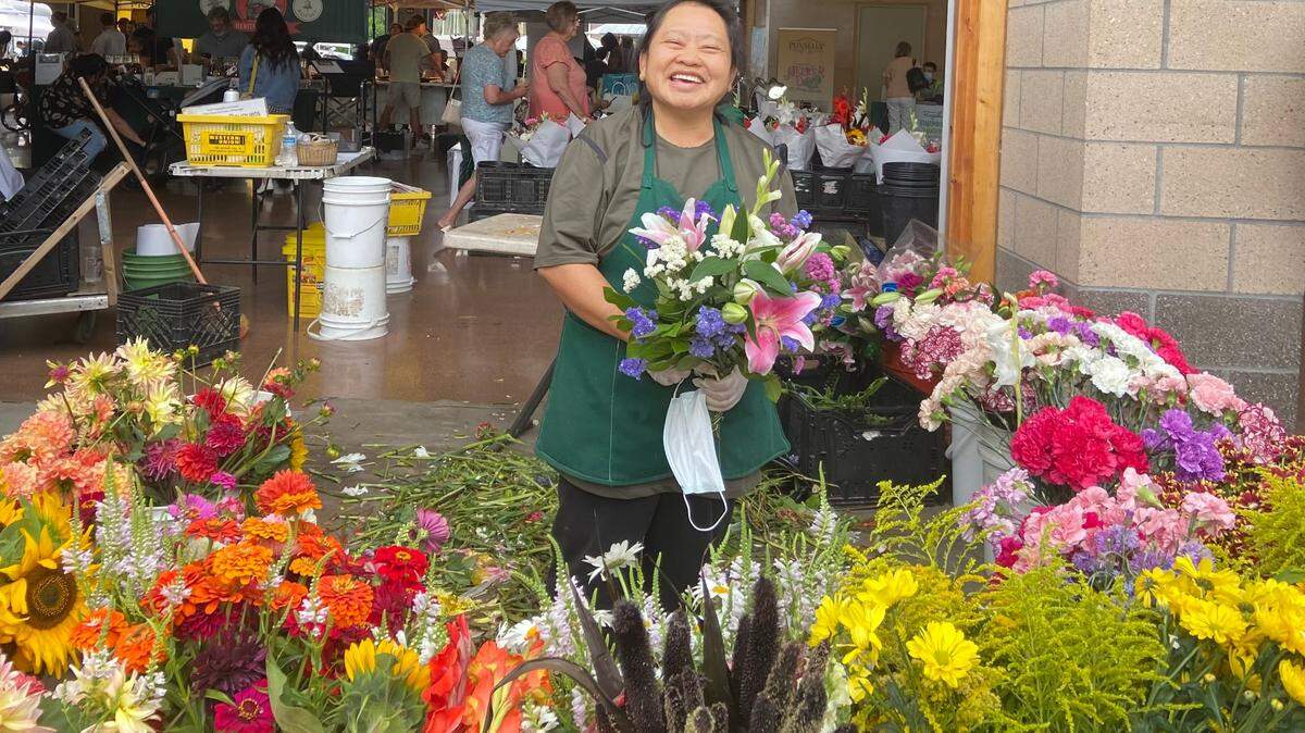 Shua H’Vang is Hmong. She has been selling flowers at the Puyallup Farmers Market for 21 years. H’Vang is proud of fellow Hmong Suni Lee and her gold in gymnastics at the Tokyo Olympics.
