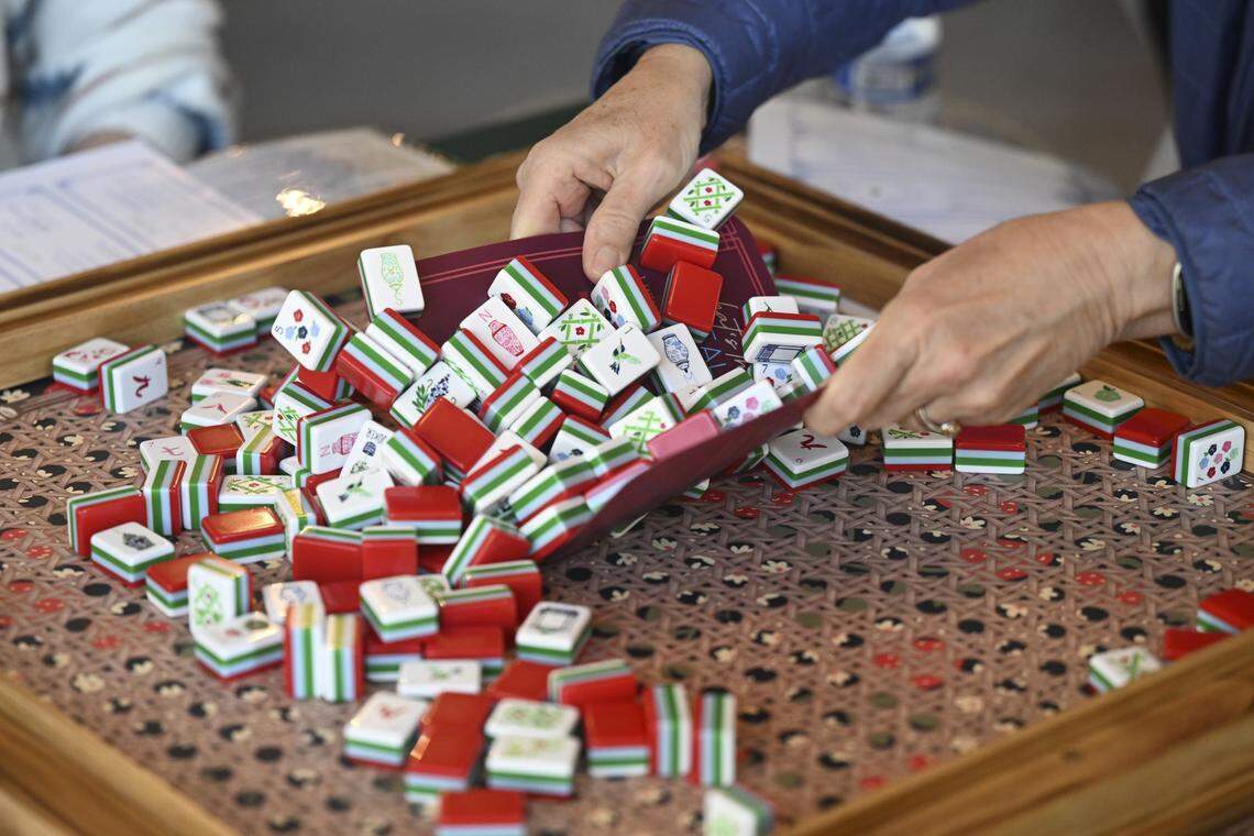 Participants in a Mahj with Mandee class practice shuffling mahjong tiles on Thursday, April 9, 2026, at the Kindship Studio in Gig Harbor, Wash.