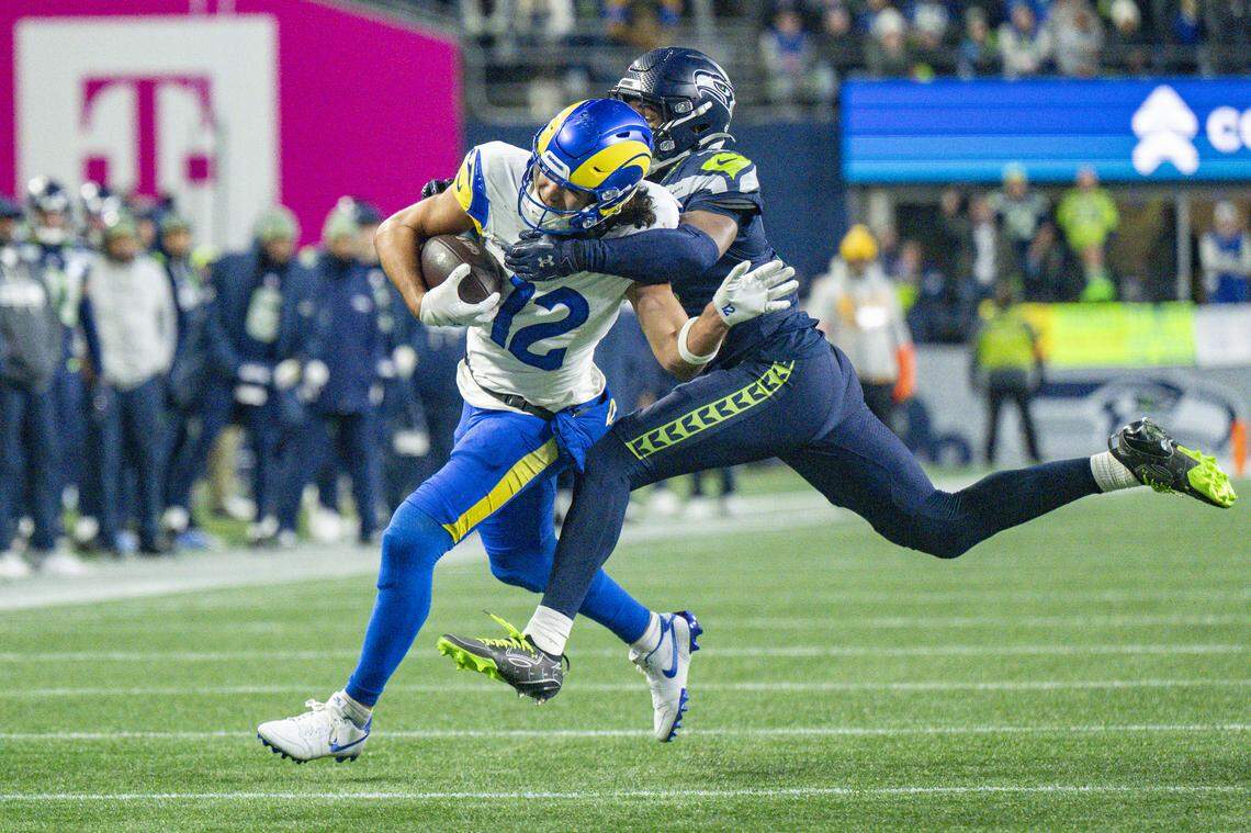 Rams wide receiver Puka Nacua (12) pushes off Seattle Seahawks safety Nick Emmanwori (3) as he tries to tackle Nacua during the NFC Championship game at Lumen Field, on Sunday, Jan. 25, 2026, in Seattle.