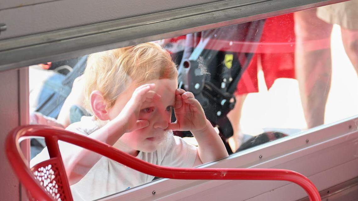 Alton Nemier, 2, peers into the shop as he waited with his parents and brother during the grand opening on Thursday.