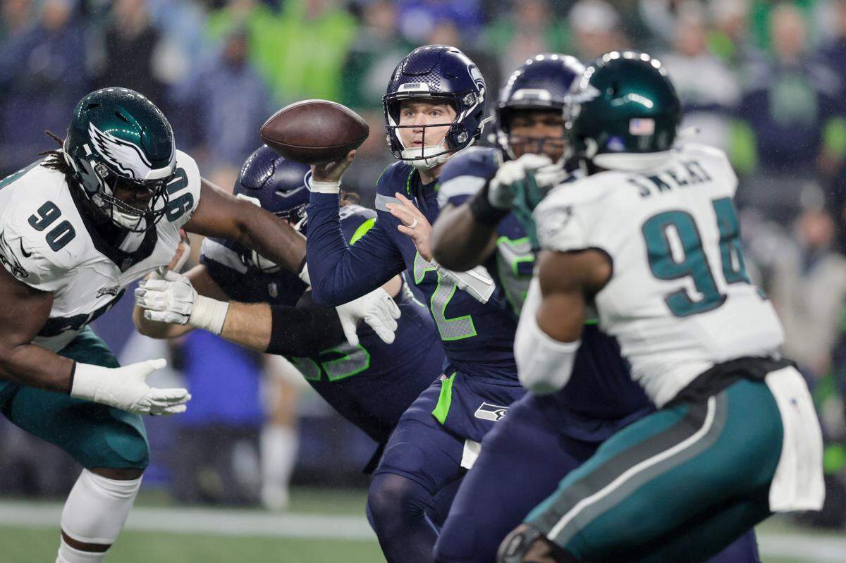 Seattle Seahawks quarterback Drew Lock, center, looks to pass against the Philadelphia Eagles during the first half of an NFL football game, Monday, Dec. 18, 2023, in Seattle. (AP Photo/John Froschauer)