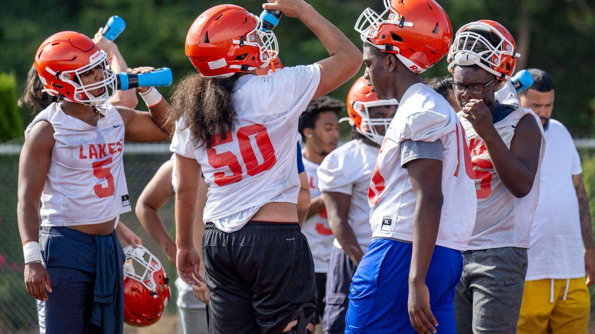 Lakes linemen take a hydration break during practice on Friday, Aug. 18, 2023, at Lakes High School in Lakewood, Wash.