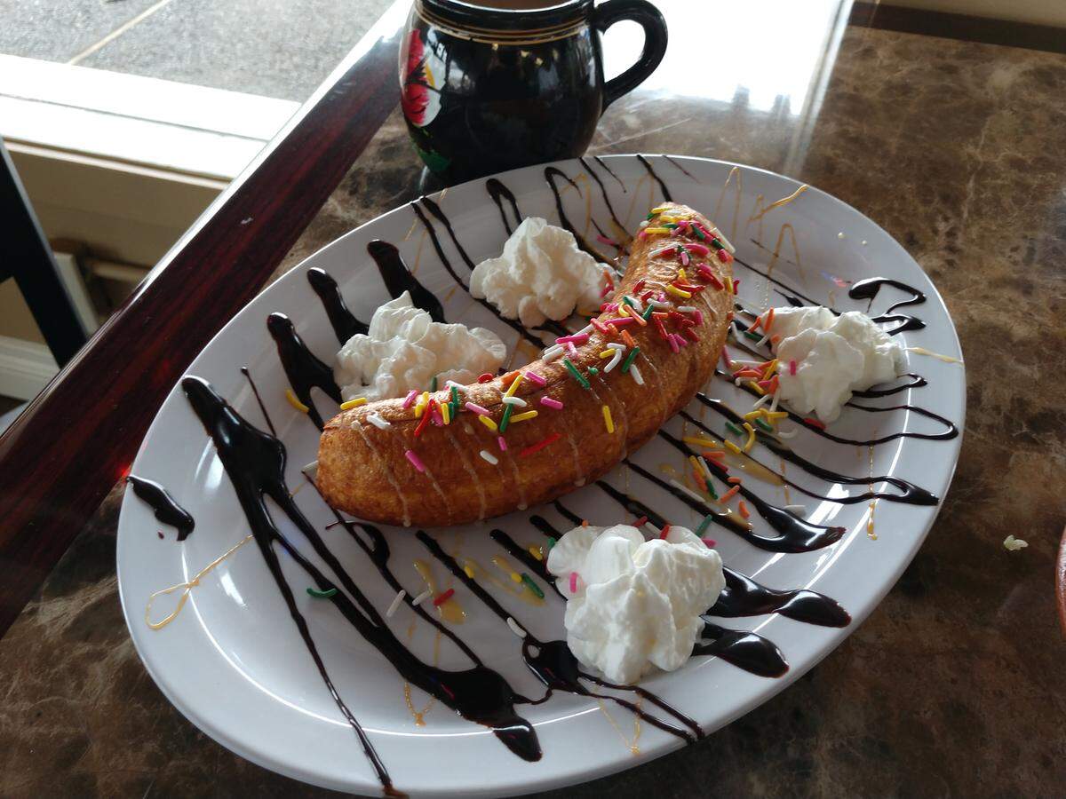 A fried plantain and mug of champurrado from Mi Casa Mexican Restaurant in Lakewood.