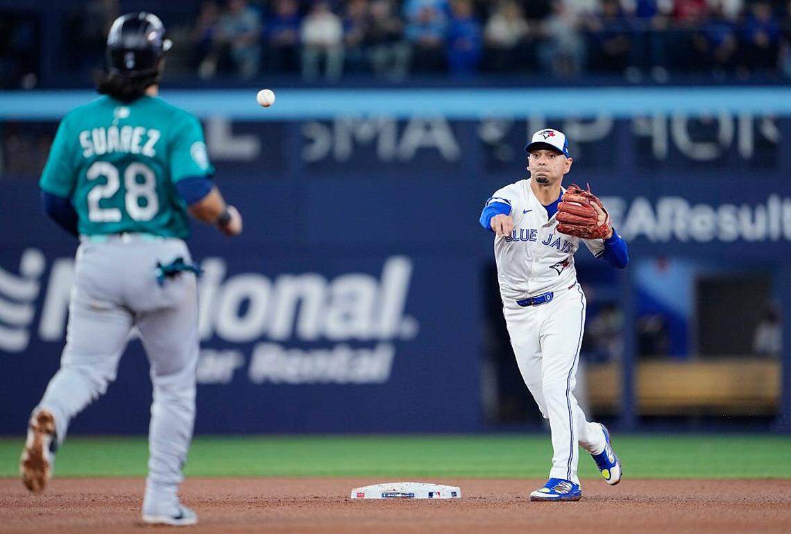 TORONTO, ONTARIO - OCTOBER 19: Andres Gimenez #0 of the Toronto Blue Jays throws to first base after forcing out Eugenio Suarez #28 of the Seattle Mariners at second base to complete a double play during the fourth inning in game six of the American League Championship Series at Rogers Centre on October 19, 2025 in Toronto, Ontario. (Photo by Mark Blinch/Getty Images)