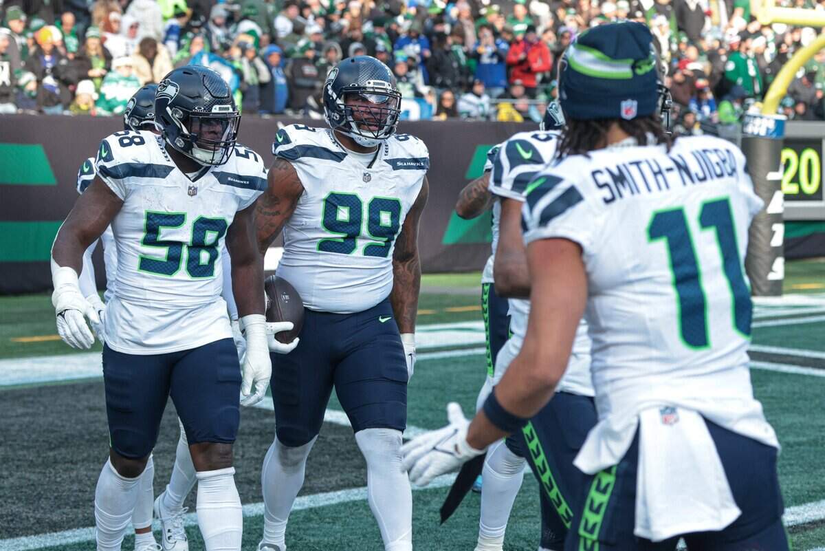 Seattle Seahawks defensive end Leonard Williams (99) celebrates his fumble return for a touchdown during the first half against the New York Jets at MetLife Stadium. Mandatory Credit: Vincent Carchietta-Imagn Images