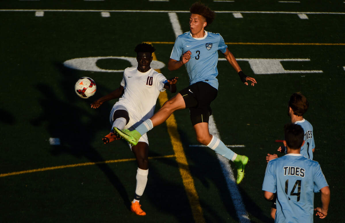 Wilson’s Mathdan Yel (10) and Gig Harbor’s Nate Jones (3) go after a loose ball in the first half. Wilson played Gig Harbor in a soccer match at Mount Tahoma High School in Tacoma, Wash., on Thursday, May 9, 2019.
