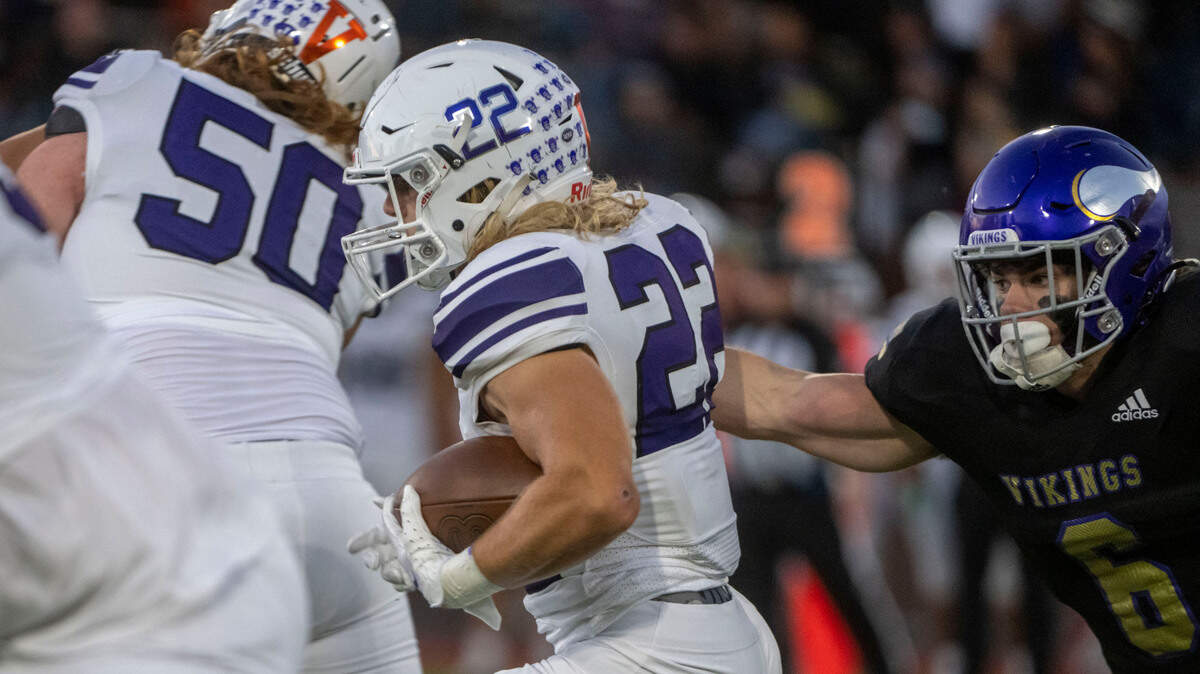 Sumner running back Matthew Spurbeck breaks through a tackle attempt by Puyallup’s Wyatt Gordon during the first quarter of a 4A SPSL game on Friday, Sept. 23, 2022, at Sparks Stadium in Puyallup, Wash.