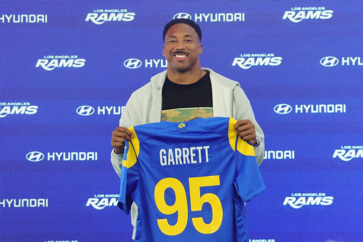 WOODLAND HILLS, CALIFORNIA - JUNE 2: Myles Garrett #95 of the Los Angeles Rams poses with his jersey during a press conference after an organized team activities workout at Rams Village at the Warner Center on June 2, 2026, in Woodland Hills, California. (Photo by Kevin Terrell/Getty Images)