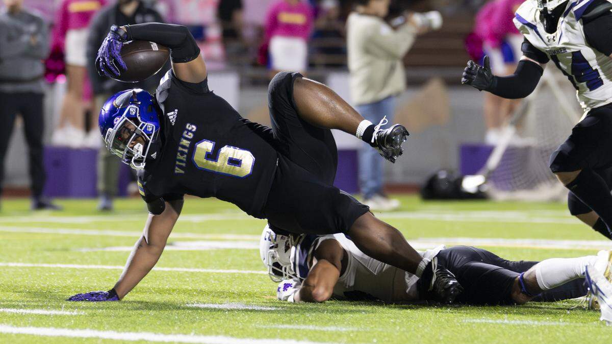 Puyallup running back Malcolm Akuffo (6) rolls over Sumner free safety Elias Isaacs (27) on his way to score a touchdown during the first half of the game at Sparks Stadium, on Saturday, Oct. 4, 2025, in Puyallup, Wash.