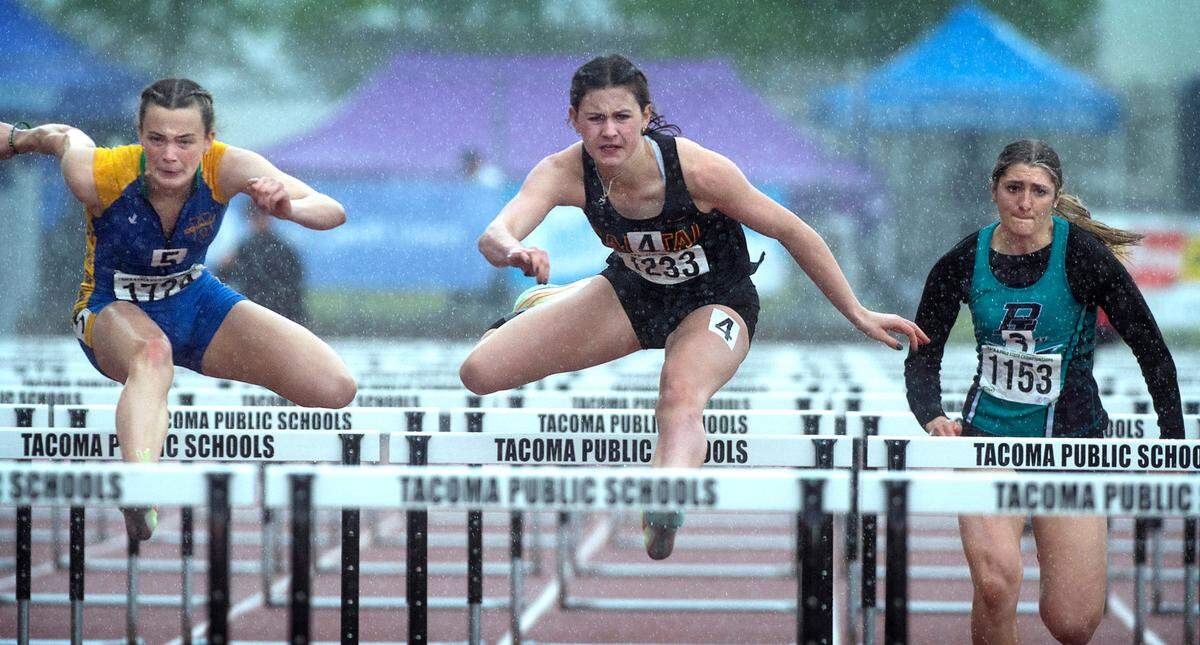 Capital junior Hana Moll (center) runs to a state championship in the 3A girls 100-meter hurdles during the second day of the WIAA State Track and Field Championships at Mount Tahoma High School in Tacoma, Washington on Friday, May 27, 2022.