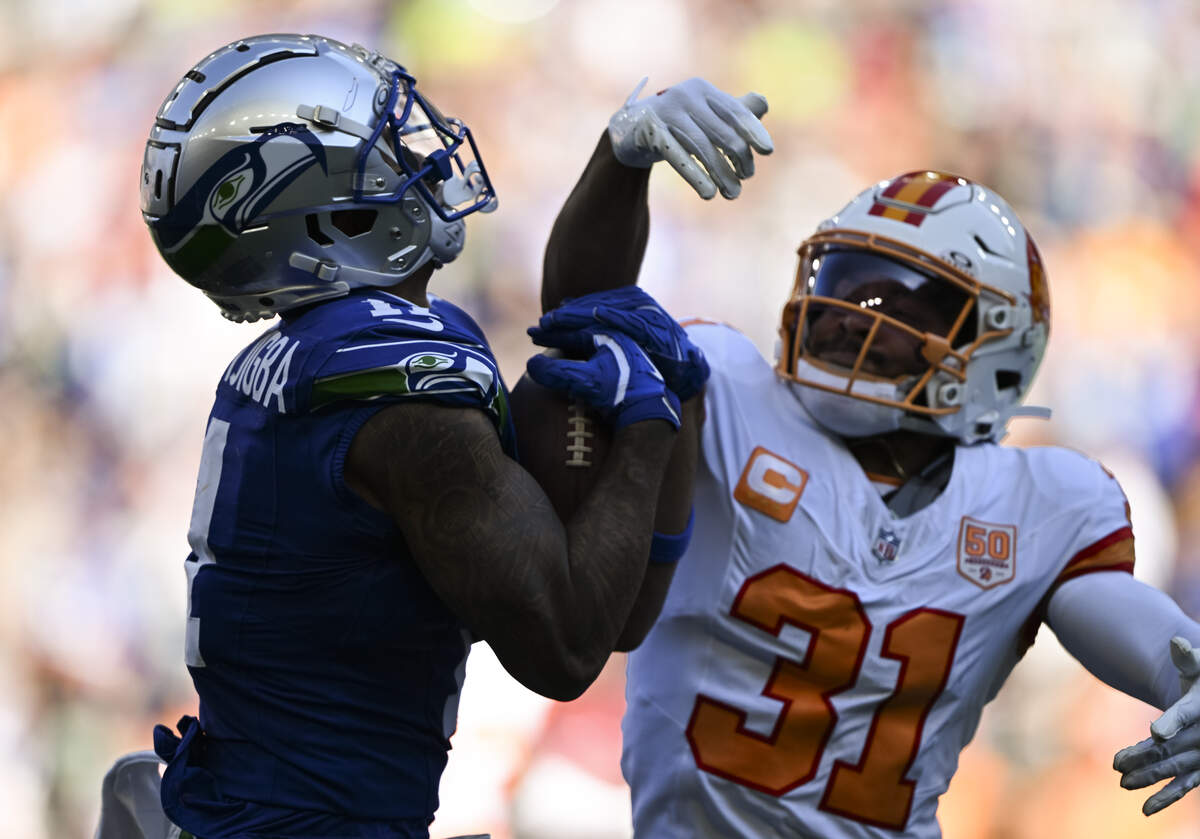 Seattle Seahawks wide receiver Jaxon Smith-Njigba (11) makes a 53-yard catch against Tampa Bay Buccaneers safety Antoine Winfield Jr. (31) during the third quarter of the game at Lumen Field, on Sunday, Oct. 5, 2025, in Seattle.