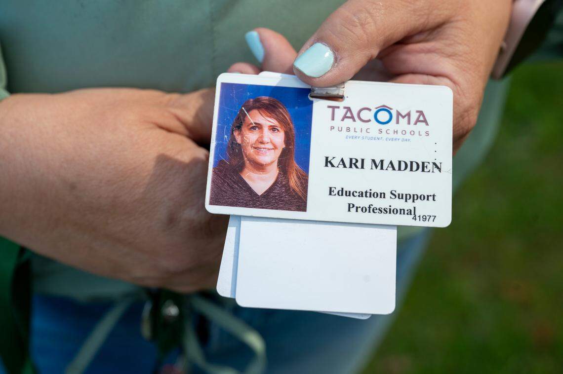 A worn Tacoma Public Schools ID is held by Kari Madden, president of Tacoma Federation of Education Support Professionals, the union that represents ESPs, as she stands near Foss High School, where Madden currently works, on Wednesday, May 21, 2025, in Tacoma.