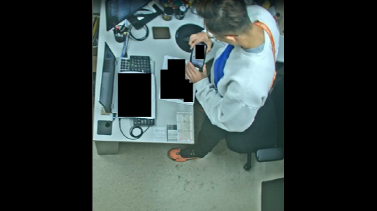 Surveillance video from Sgt. Jian Zhao's office at Joint Base Lewis-McChord allegedly shows him taking photos of restricted military documents on Oct. 27, 2024 that he sold to an individual in China for $4,500.