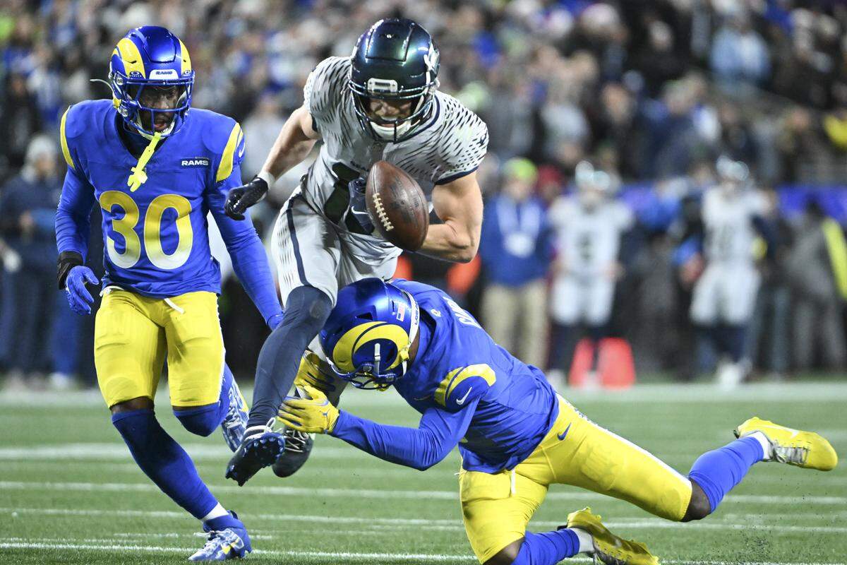 The ball is knocked from the hands of Seattle Seahawks wide receiver Cooper Kupp (10) during the second quarter of the game against the Los Angeles Rams at Lumen Field, on Thursday, Dec. 18, 2025, in Seattle.
