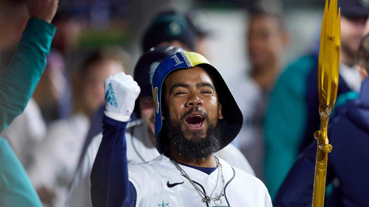 Seattle Mariners right fielder Teoscar Hernandez celebrates in the dugout after his home run against the St. Louis Cardinals during the sixth inning of a baseball game Saturday, April 22, 2023, in Seattle. (AP Photo/John Froschauer)