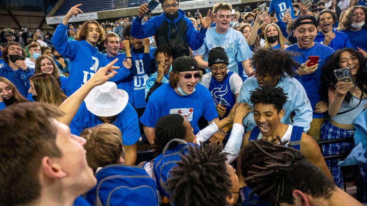 Curtis players celebrate in front of their student section after beating Union, 49-40, in a Class 4A state tournament semifinal game on Friday, March 4, 2022, at the Tacoma Dome, in Tacoma, Wash.