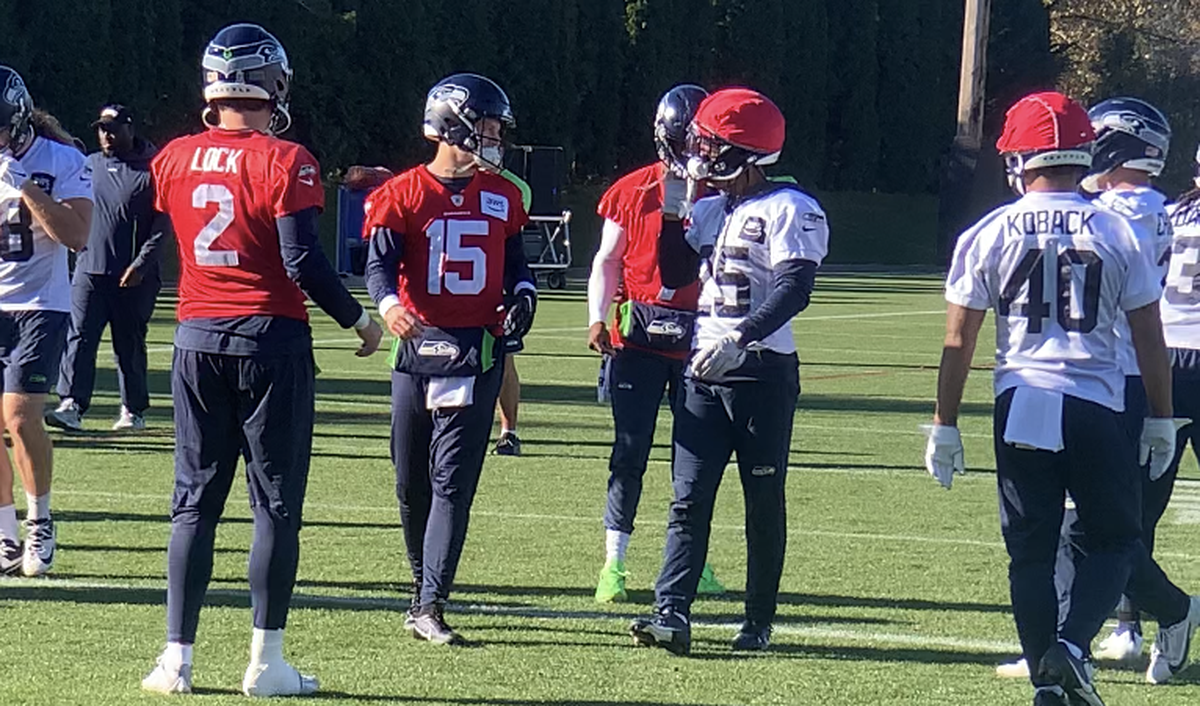 New third quarterback Brett Rypien (15), from Spokane and Boise State, talks with rookie running back Kenny McIntosh (25) at Seahawks practice Friday, Nov. 17, 2023, two days before Seattle was to play Rypien’s former Los Angeles Rams.
