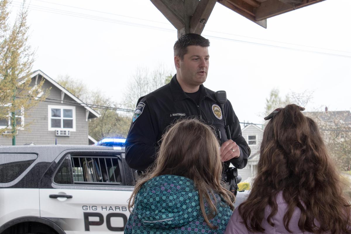 Gig Harbor police officer Jeff Martineau talked about life jackets, how to safety walk on boardwalks and Gig Harbor police's marine unit during a school field trip to Skansie Park with Saint Nicholas Catholic School students on April 13.