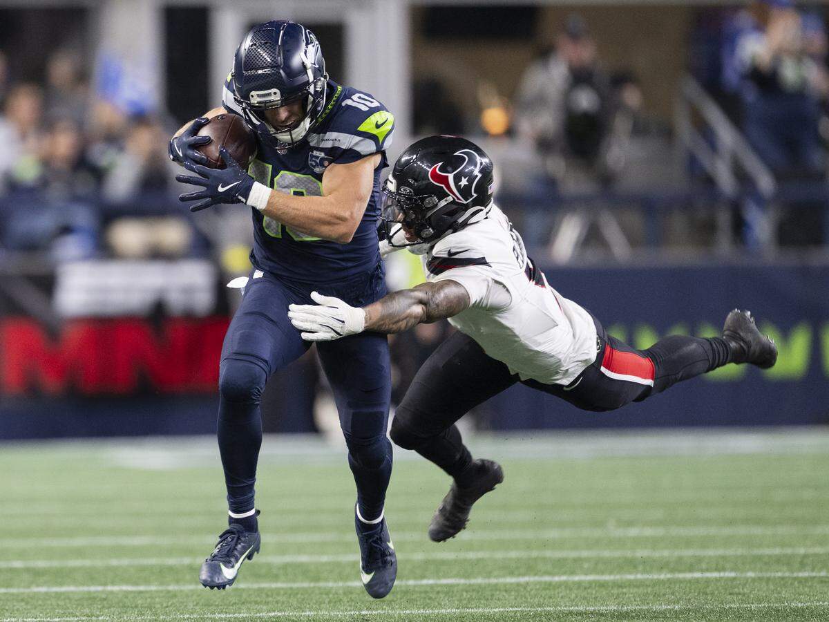 Seattle Seahawks wide receiver Cooper Kupp (10) picks up 32 yard against Houston Texans safety Jalen Pitre (5) during the first quarter of the game at Lumen Field, on Monday, Oct. 20, 2025, in Seattle.