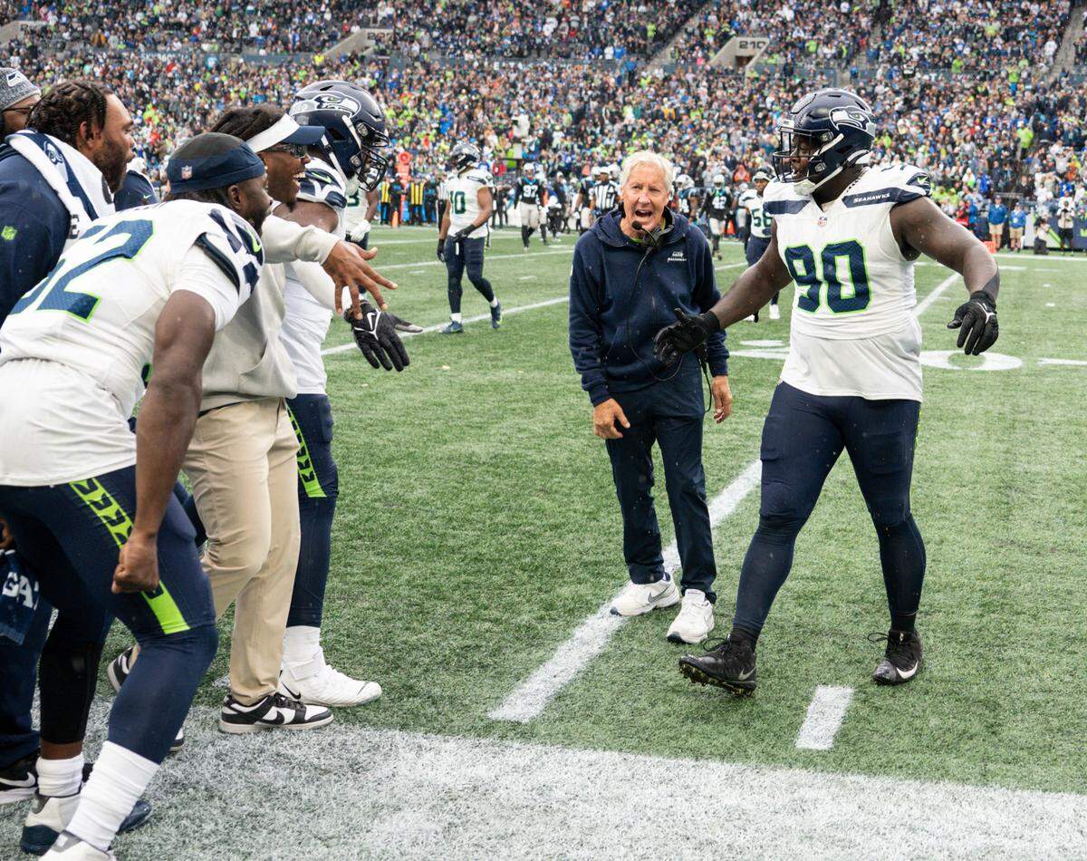 Seattle Seahawks head coach Pete Carroll celebrates a sack with Seattle Seahawks defensive tackle Jarran Reed (90) during the fourth quarter of the game against the Carolina Panthers at Lumen Field, Sunday, Sept. 24, 2023, Seattle, Wash.