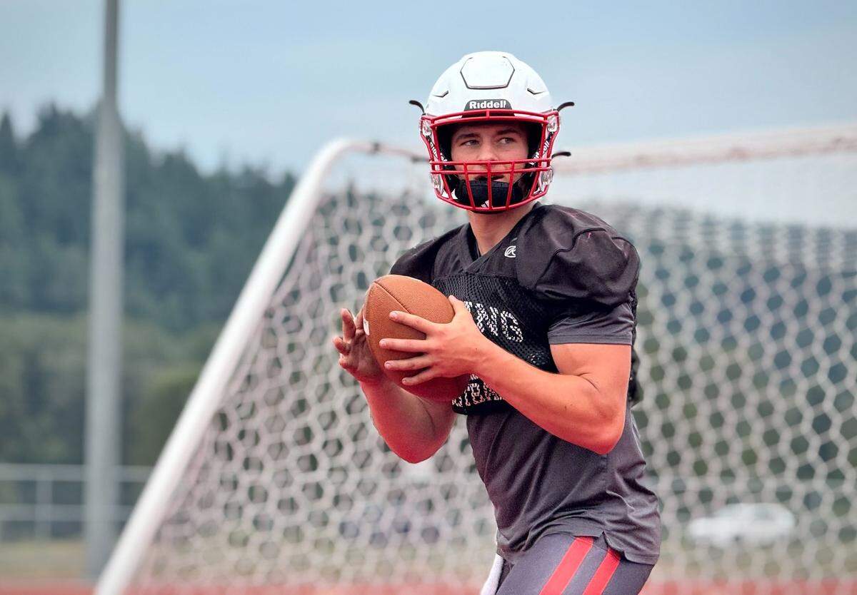 Orting QB Kyle Curtis runs through practice drills at Cardinal Stadium on Aug. 27, 2025, in Orting.