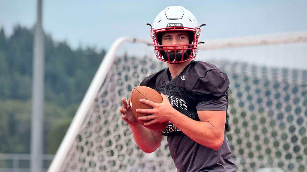 Orting QB Kyle Curtis runs through practice drills at Cardinal Stadium on Aug. 27, 2025, in Orting, Wash.