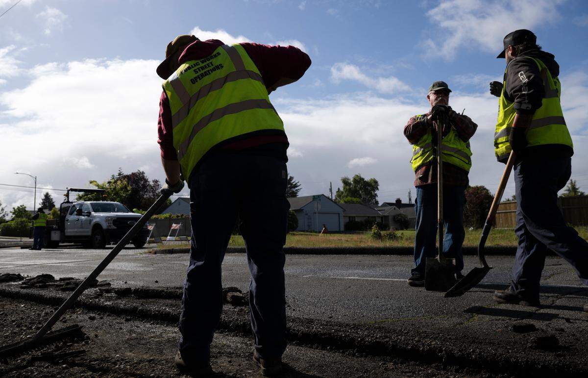 A Tacoma Public Works crew works to replace asphalt along North 21st Street , on Monday, June 3, 2024, in Tacoma, Wash.