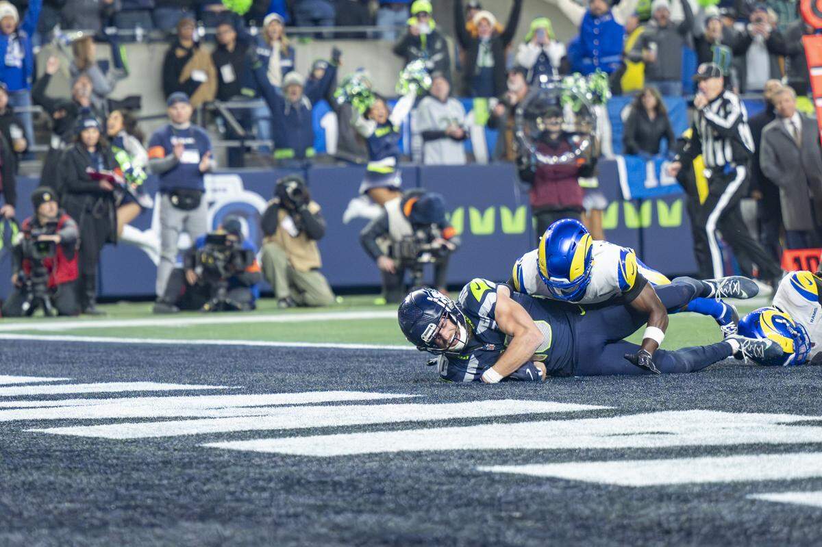Seattle Seahawks wide receiver Cooper Kupp (10) lands in the end zone for a touchdown against the Rams during the NFC Championship game at Lumen Field, on Sunday, Jan. 25, 2026, in Seattle.