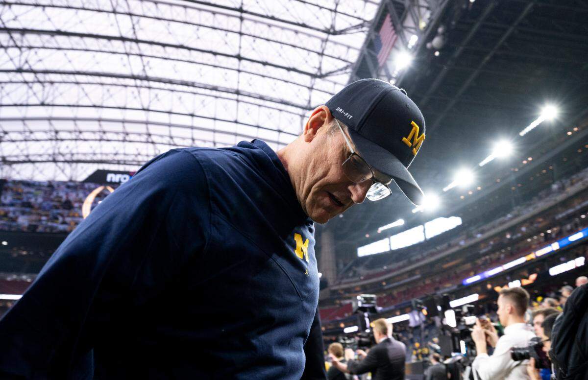 Michigan Wolverines head coach Jim Harbaugh arrives ahead of the College Football Playoff National Championship game against the Washington Huskies at NRG Stadium on Monday, Jan. 8, 2024, in Houston.