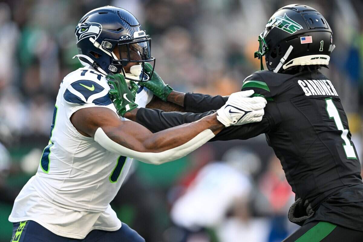 Dec 1, 2024; East Rutherford, New Jersey, USA; Seattle Seahawks wide receiver DK Metcalf (14) blocks against New York Jets cornerback Sauce Gardner (1) during the third quarter at MetLife Stadium. Mandatory Credit: Mark Smith-Imagn Images