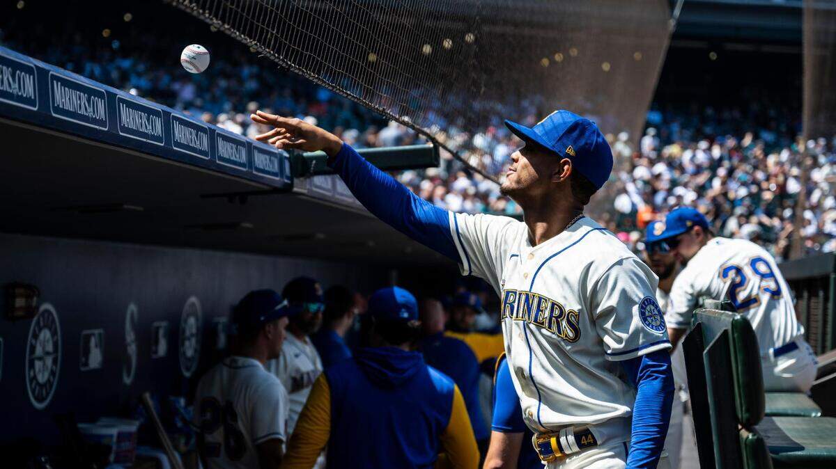 Seattle Mariners center fielder Julio Rodriguez (44) throws a ball back to a fan after signing it before the start of the game at T-Mobile Park on Sunday, July 24, 2022 in Seattle, Wash.